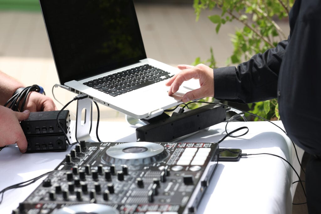 iDj Entertainment DJ setting up equipment outdoors in Los Angeles, CA for an event.
