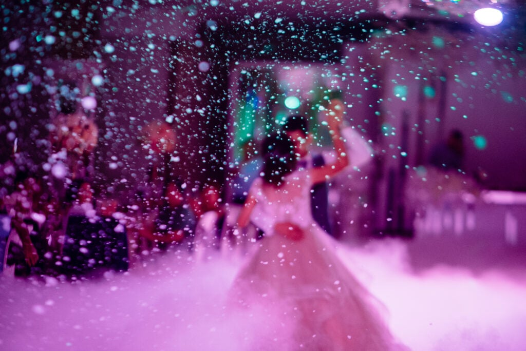 iDj Entertainment event in Los Angeles with vibrant dance floor lights and confetti.