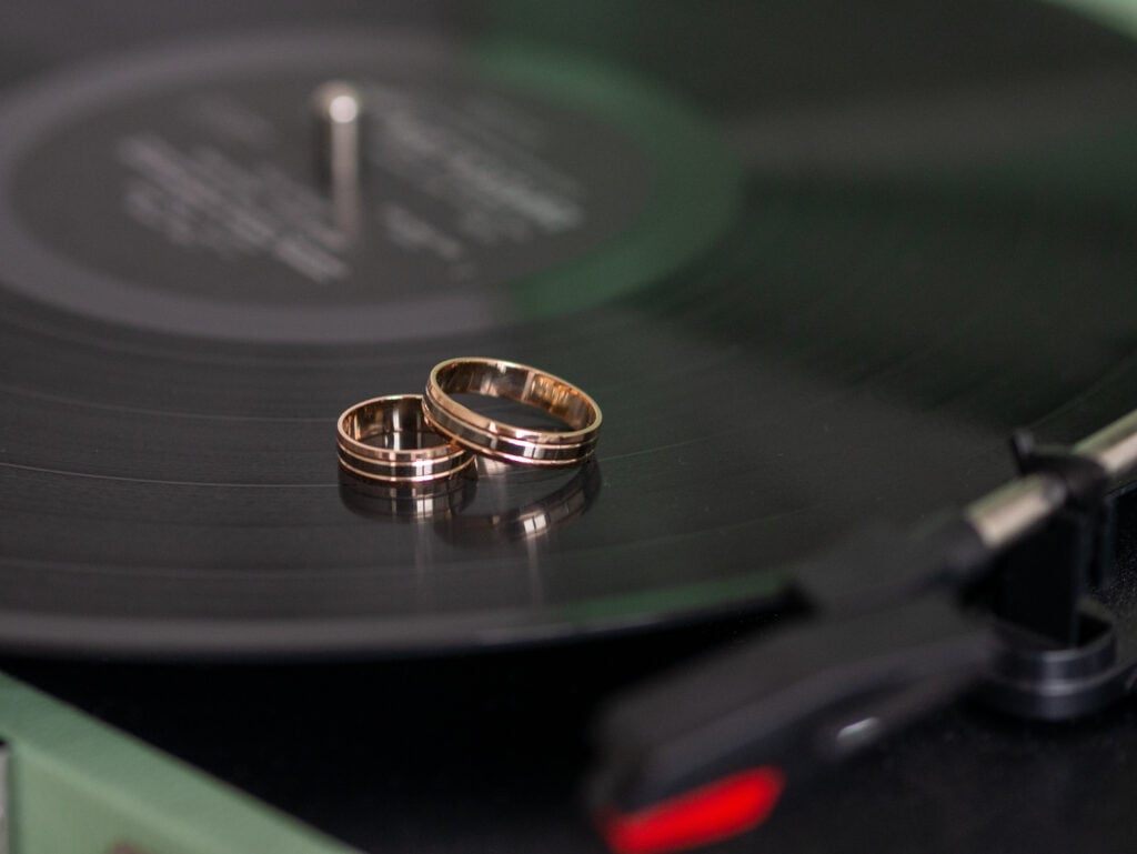 Closeup wedding rings of bride and groom on gramophone