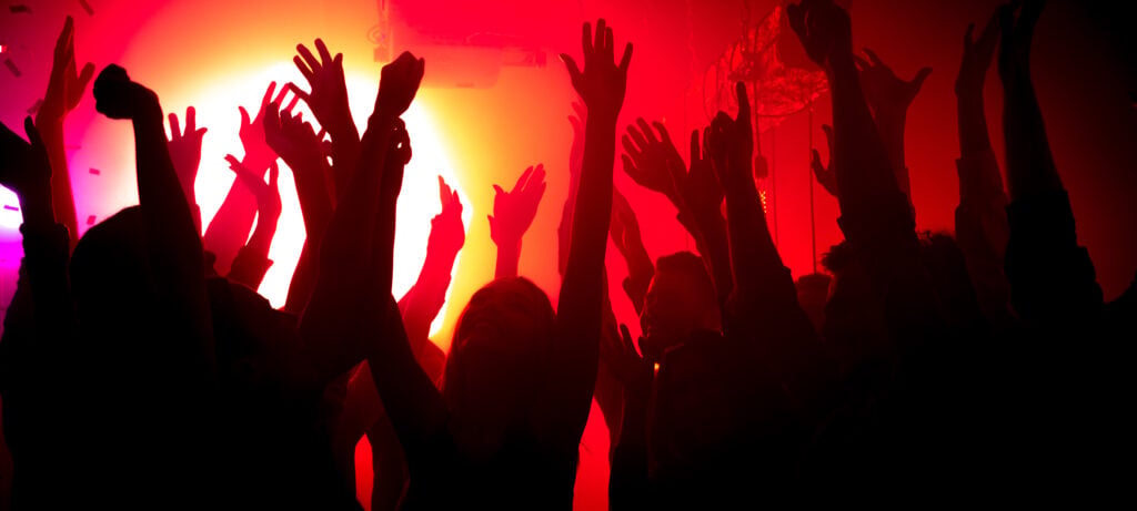 Photo of modern carefree silhouette bachelors fellows have anniversary prom celebration raise hands up air dj bright glitter festival